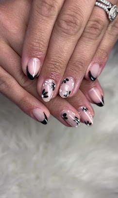 Nude nails with black floral French tips