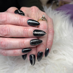 Black glitter stiletto nails with rhinestones